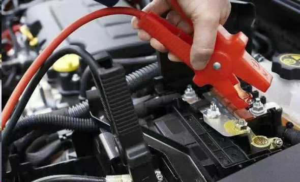 How Many Volts Is a Car Battery Illustration of a standard automotive battery with a multimeter measuring its voltage.